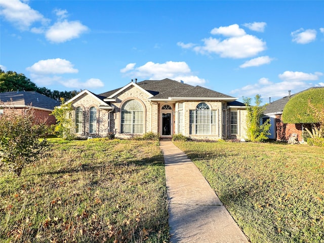 ranch-style home with a front lawn