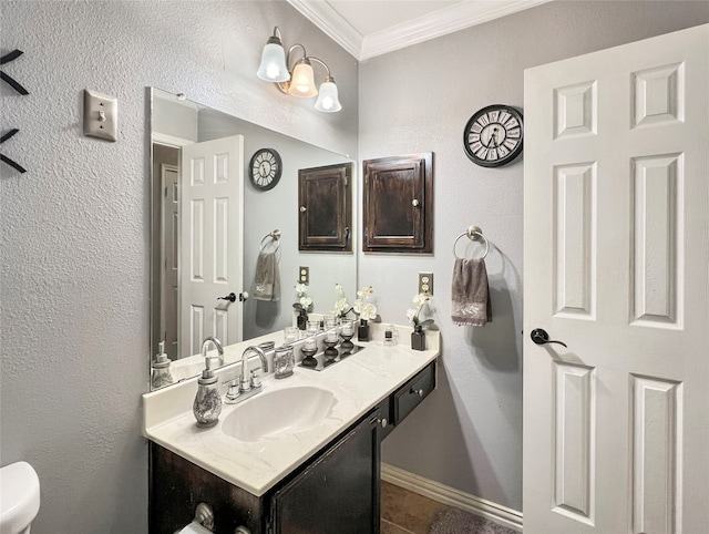 bathroom featuring vanity, toilet, and ornamental molding