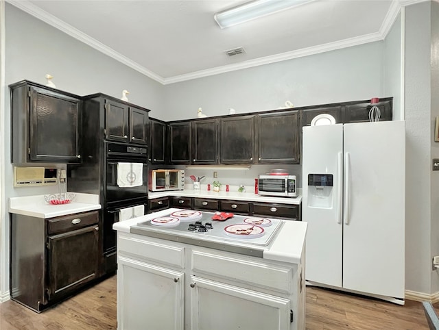 kitchen with a center island, white appliances, light hardwood / wood-style floors, and crown molding