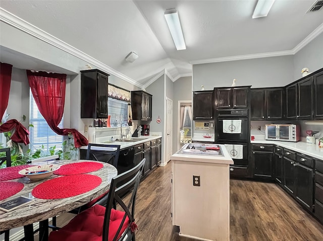 kitchen with sink, ornamental molding, dark wood-type flooring, and double oven