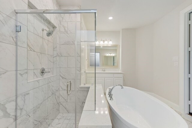 bathroom featuring vanity and separate shower and tub