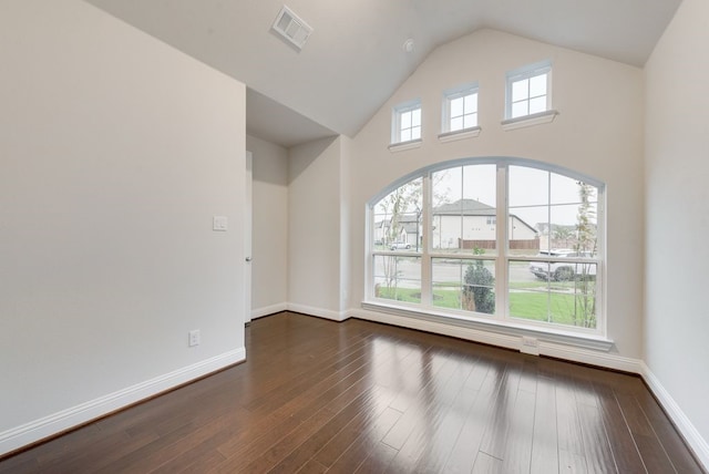 empty room with dark wood-type flooring and a healthy amount of sunlight