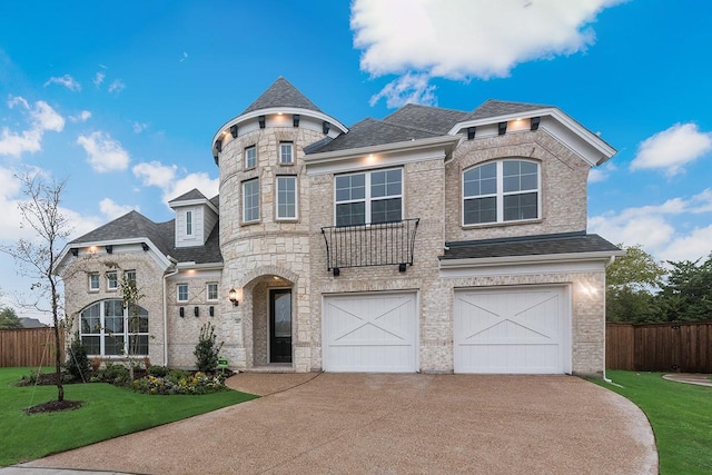 view of front of property with a garage and a front lawn