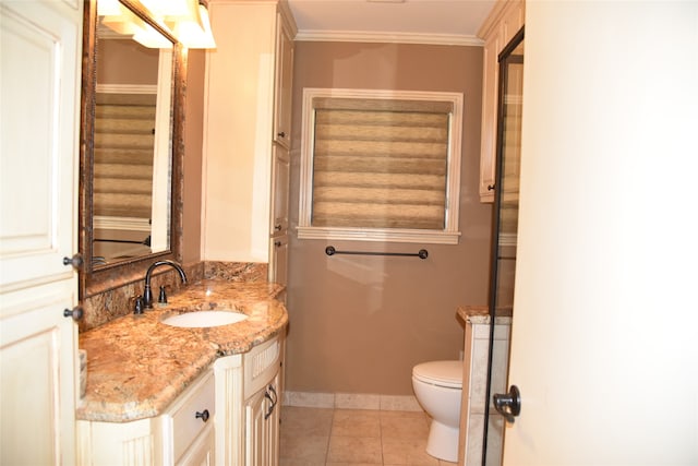 bathroom with tile patterned floors, toilet, vanity, and ornamental molding