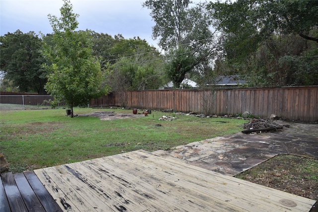 wooden terrace with a lawn