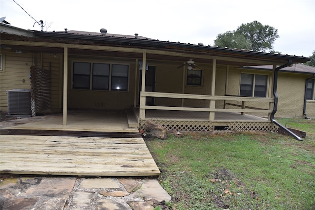 rear view of property featuring central AC, ceiling fan, and a wooden deck