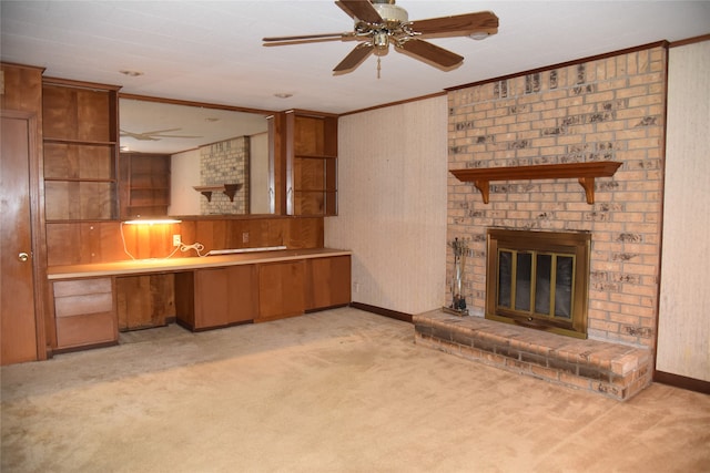 unfurnished living room with ceiling fan, crown molding, a fireplace, and light carpet