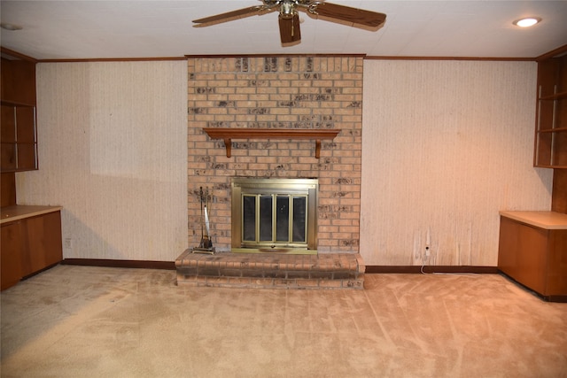 unfurnished living room featuring ceiling fan, ornamental molding, light colored carpet, and a brick fireplace