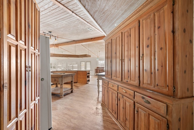 hall with rail lighting, wood ceiling, and concrete floors