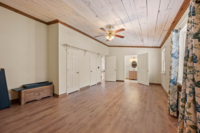 living area featuring wooden ceiling, crown molding, baseboards, and wood finished floors