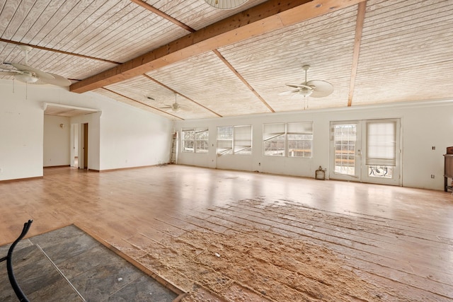 unfurnished living room featuring wood-type flooring, wood ceiling, ceiling fan, beamed ceiling, and baseboards