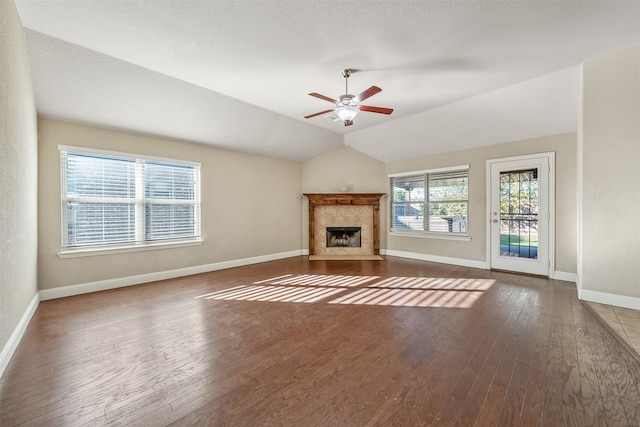 unfurnished living room with dark hardwood / wood-style floors, a healthy amount of sunlight, and vaulted ceiling