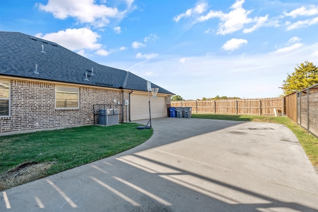 back of house with a lawn and a garage