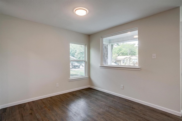 spare room with dark hardwood / wood-style flooring