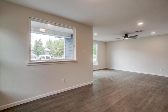 spare room with ceiling fan and dark wood-type flooring