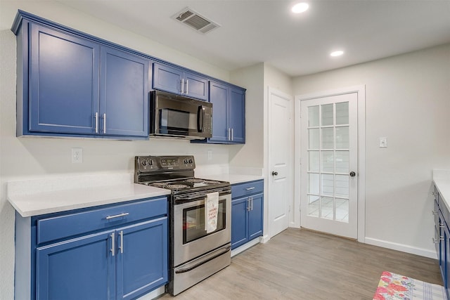 kitchen featuring blue cabinets, electric stove, and light hardwood / wood-style floors