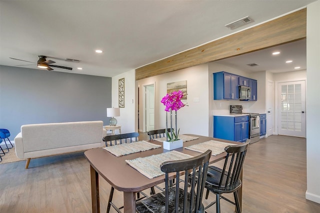 dining space with wood finished floors, visible vents, and recessed lighting