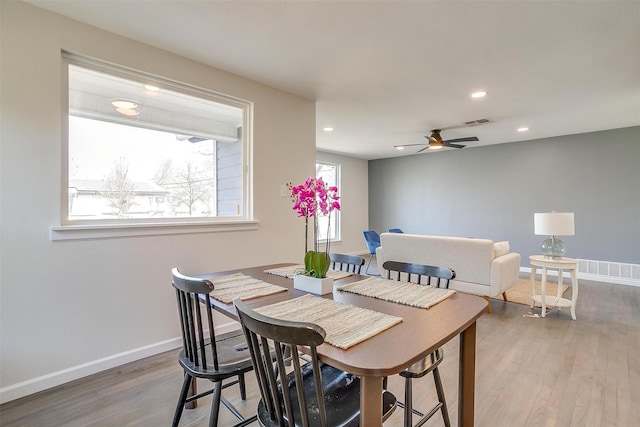 dining space with baseboards, recessed lighting, visible vents, and light wood-style floors