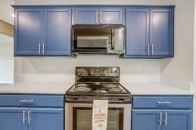 kitchen featuring stainless steel electric range oven and blue cabinetry