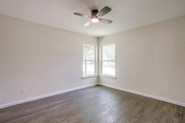 unfurnished room with ceiling fan and dark hardwood / wood-style flooring