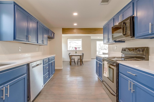 kitchen with stainless steel appliances, recessed lighting, visible vents, blue cabinets, and light wood-type flooring