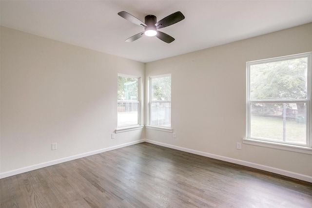 spare room with ceiling fan and dark hardwood / wood-style floors