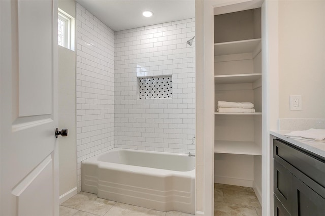 bathroom with shower / tub combination, vanity, baseboards, a spacious closet, and tile patterned floors