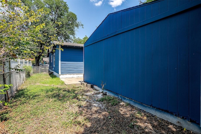 view of yard with an outdoor structure and fence