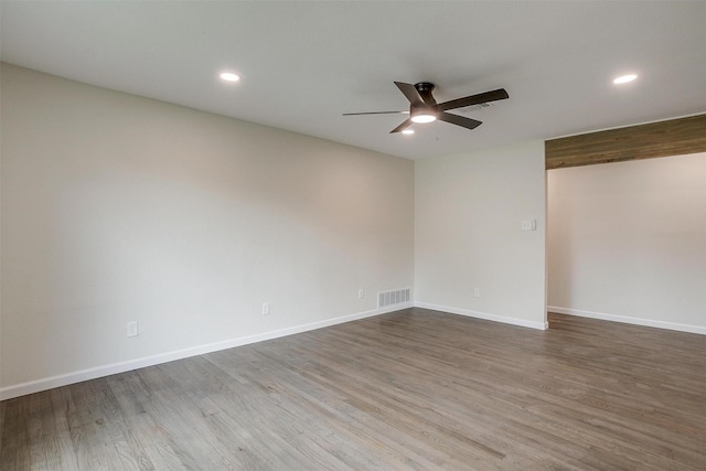 spare room featuring hardwood / wood-style flooring and ceiling fan