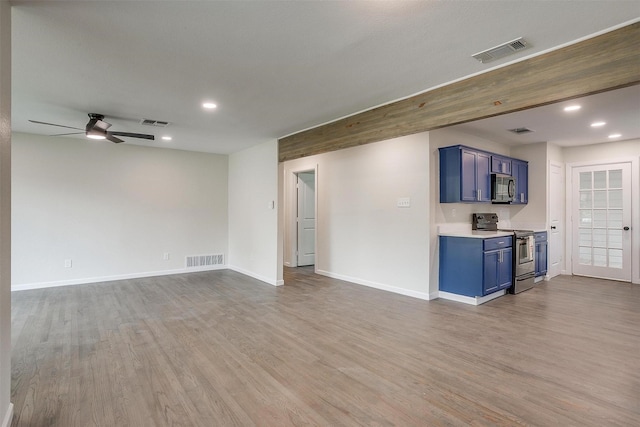 unfurnished living room featuring ceiling fan and wood-type flooring