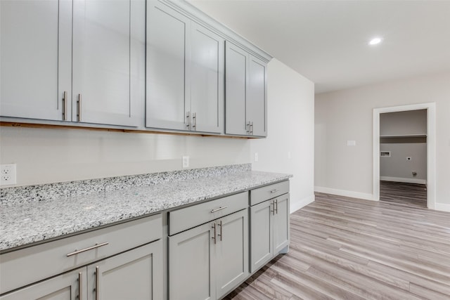 kitchen featuring light stone counters and light hardwood / wood-style floors