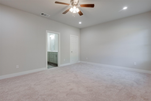 empty room featuring ceiling fan and carpet