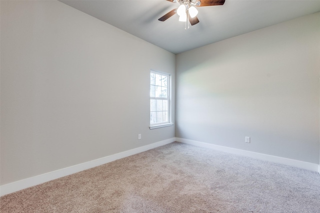 empty room with ceiling fan and carpet