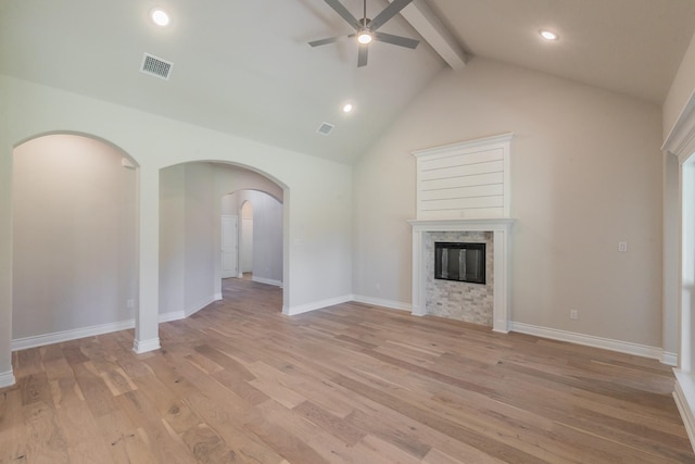 609 Keel Way, Azle, TX 76020 - unfurnished living room featuring ceiling fan, arched walkways, light wood finished floors, a glass covered fireplace, and recessed lighting
