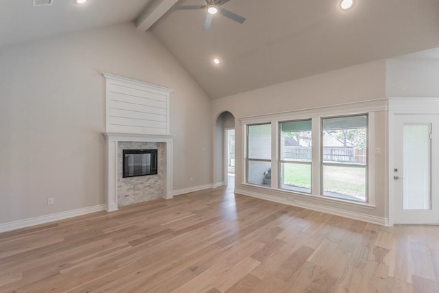 609 Keel Way, Azle, TX 76020 - unfurnished living room with beam ceiling, ceiling fan, arched walkways, light wood-type flooring, and recessed lighting