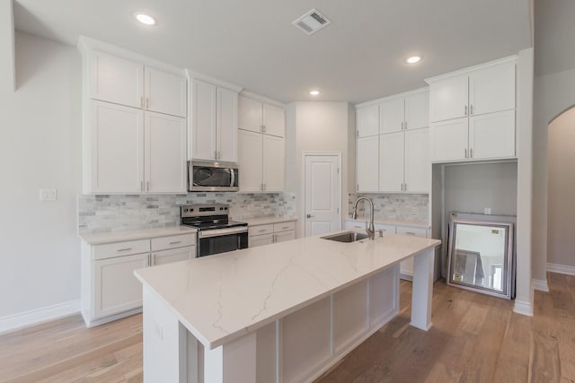 609 Keel Way, Azle, TX 76020 - kitchen with stainless steel appliances, white cabinets, light wood-style flooring, and recessed lighting