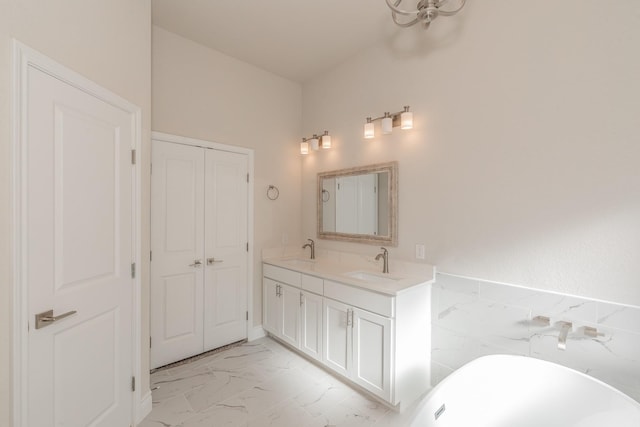 609 Keel Way, Azle, TX 76020 - bathroom featuring marble look tile flooring, a freestanding tub, and double vanity
