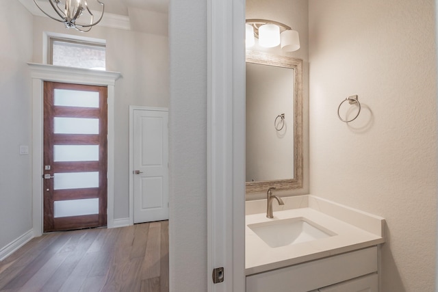 609 Keel Way, Azle, TX 76020 - bathroom with vanity, wood finished floors, and a chandelier