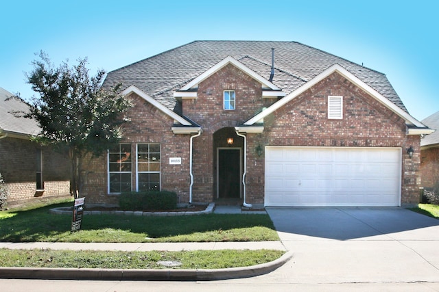 front facade with a garage and a front yard