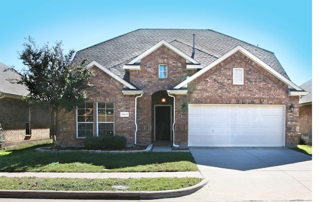 10133 Sanden, Mckinney, TX 75072 - traditional home featuring brick siding, a garage, driveway, and a shingled roof