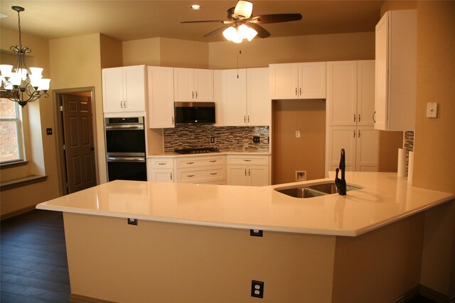 10133 Sanden, Mckinney, TX 75072 - kitchen with backsplash, appliances with stainless steel finishes, a sink, light countertops, and white cabinets
