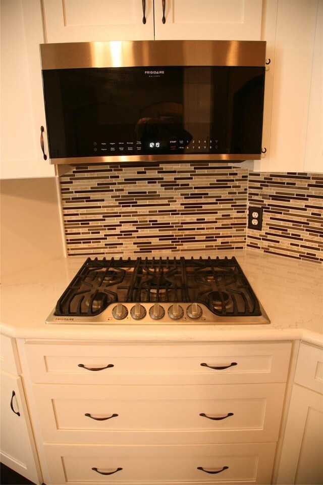 10133 Sanden, Mckinney, TX 75072 - kitchen featuring white cabinets, backsplash, appliances with stainless steel finishes, and light countertops
