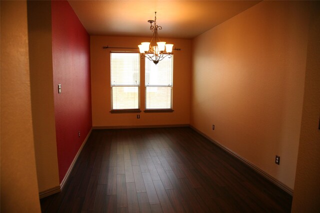 10133 Sanden, Mckinney, TX 75072 - unfurnished room with baseboards, a chandelier, and dark wood-type flooring