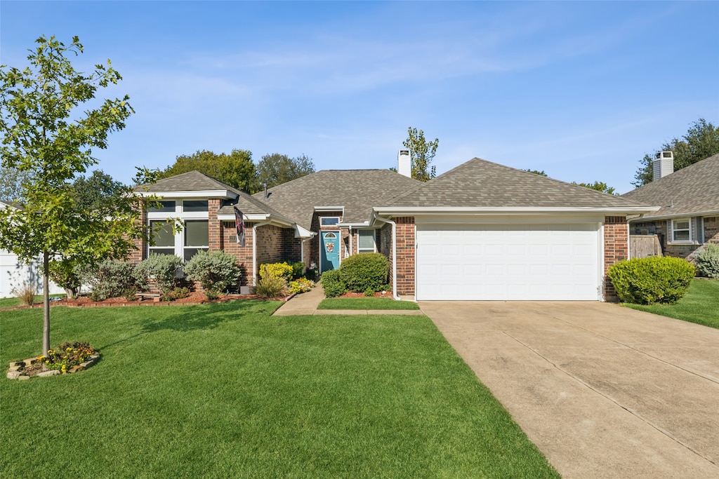 ranch-style home with a garage and a front yard