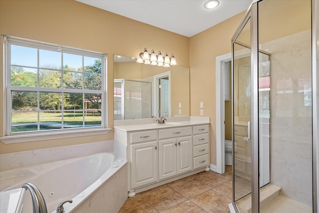 full bathroom with plus walk in shower, vanity, toilet, and tile patterned flooring