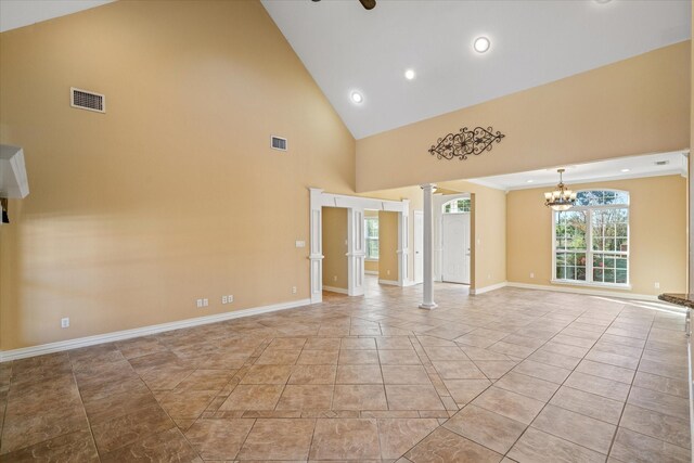 kitchen with decorative columns, tasteful backsplash, high quality fridge, stone counters, and a breakfast bar area