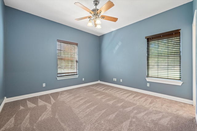 empty room featuring carpet floors and ceiling fan