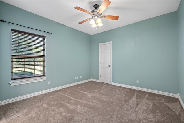 carpeted empty room featuring ceiling fan