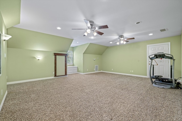 interior space featuring ceiling fan, carpet, and vaulted ceiling