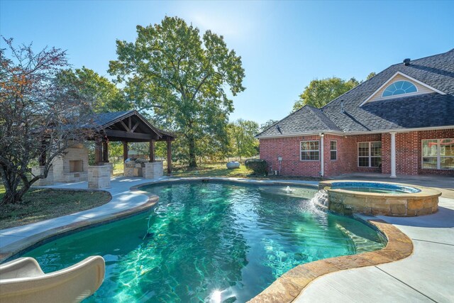 view of pool with an in ground hot tub, a gazebo, an outbuilding, and a water slide